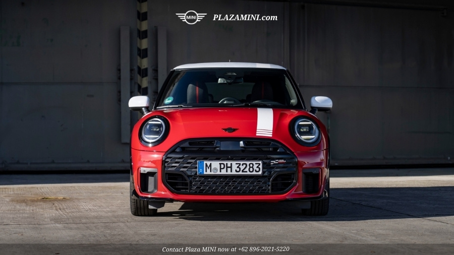 Front view red MINI 3 Door John Cooper Works Victory Edition with white stripe parked in industrial setting