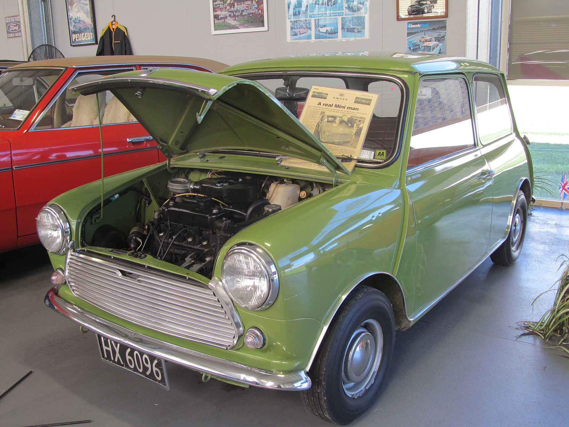 Austin Mini 1000 tahun 1977 berwarna hijau dengan kap mesin terbuka memperlihatkan mesin 998 cc